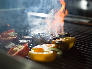 Image showing steak with vegetables on a barbecue