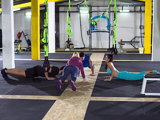 Image showing young healthy people doing pushups