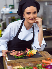 Image showing female Chef preparing beef steak