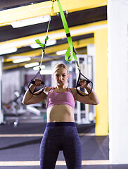 Image showing woman working out pull ups with gymnastic rings