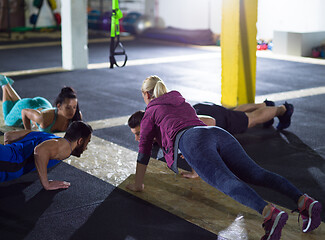 Image showing young healthy people doing pushups