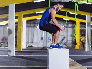 Image showing man working out jumping on fit box