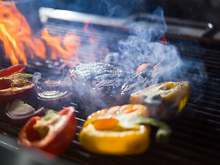 Image showing steak with vegetables on a barbecue