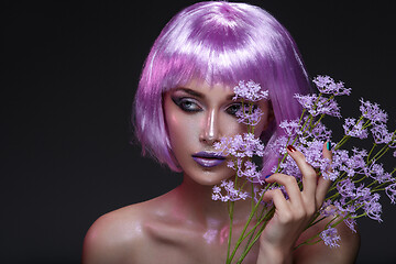 Image showing Beautiful girl in purple wig with flowers