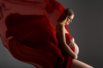 Image showing Pregnant girl in red dress