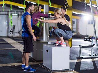 Image showing athletes working out  jumping on fit box