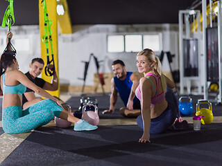 Image showing young athletes sitting on the floor and relaxing