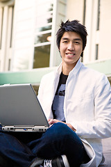 Image showing Asian male student and laptop