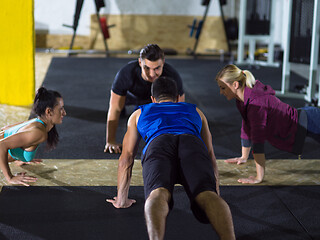 Image showing young healthy people doing pushups