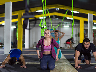 Image showing young healthy people doing pushups