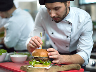 Image showing chef finishing burger