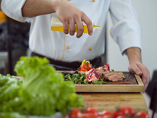 Image showing Chef finishing steak meat plate