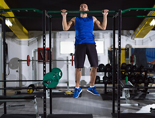 Image showing man doing pull ups on the horizontal bar