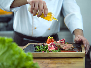 Image showing Chef finishing steak meat plate