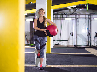 Image showing portrait of woman with red crossfitness ball