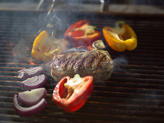 Image showing steak with vegetables on a barbecue