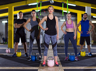 Image showing athletes doing exercises with kettlebells