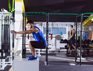 Image showing man working out jumping on fit box