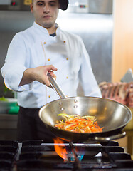 Image showing Chef doing flambe on food