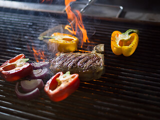 Image showing steak with vegetables on a barbecue