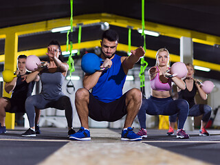 Image showing athletes doing exercises with kettlebells