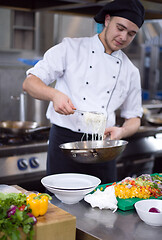 Image showing Chef hands serving spaghetti