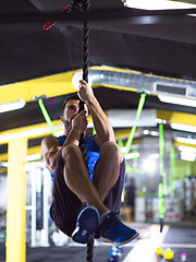 Image showing man doing rope climbing