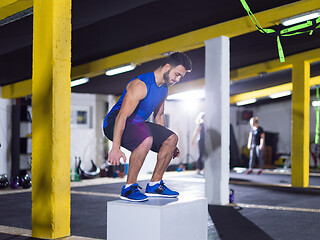 Image showing man working out jumping on fit box