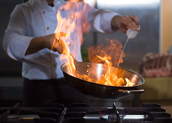 Image showing Chef doing flambe on food