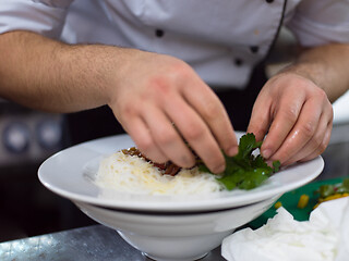 Image showing Chef hands serving spaghetti