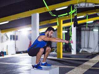 Image showing man working out jumping on fit box