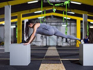 Image showing woman working out gymnastic exercise on fit boxes