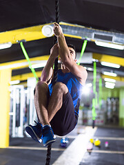 Image showing man doing rope climbing