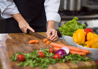 Image showing chef hands cutting carrots