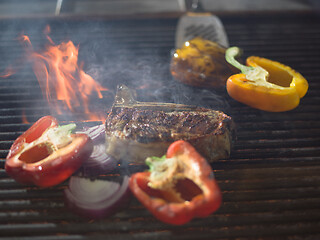 Image showing steak with vegetables on a barbecue