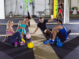 Image showing young athletes sitting on the floor and relaxing