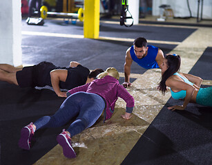 Image showing young healthy people doing pushups