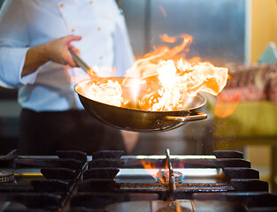 Image showing Chef doing flambe on food