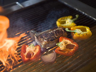 Image showing steak with vegetables on a barbecue