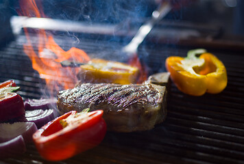 Image showing steak with vegetables on a barbecue