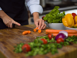 Image showing chef hands cutting carrots