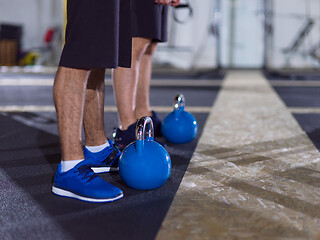 Image showing athletes doing exercises with kettlebells