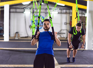 Image showing men working out pull ups with gymnastic rings