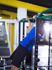 Image showing man doing pull ups on the horizontal bar