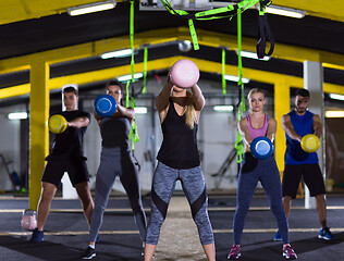 Image showing athletes doing exercises with kettlebells