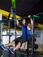 Image showing man doing pull ups on the horizontal bar