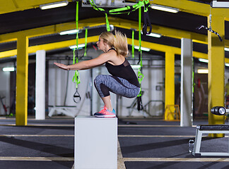 Image showing woman working out  jumping on fit box