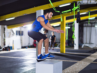 Image showing man working out jumping on fit box