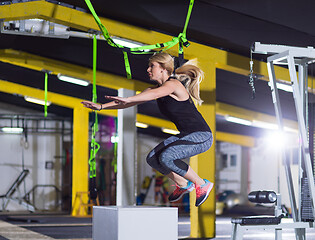 Image showing woman working out  jumping on fit box