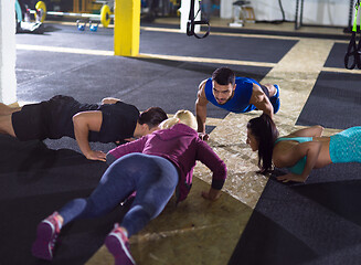 Image showing young healthy people doing pushups